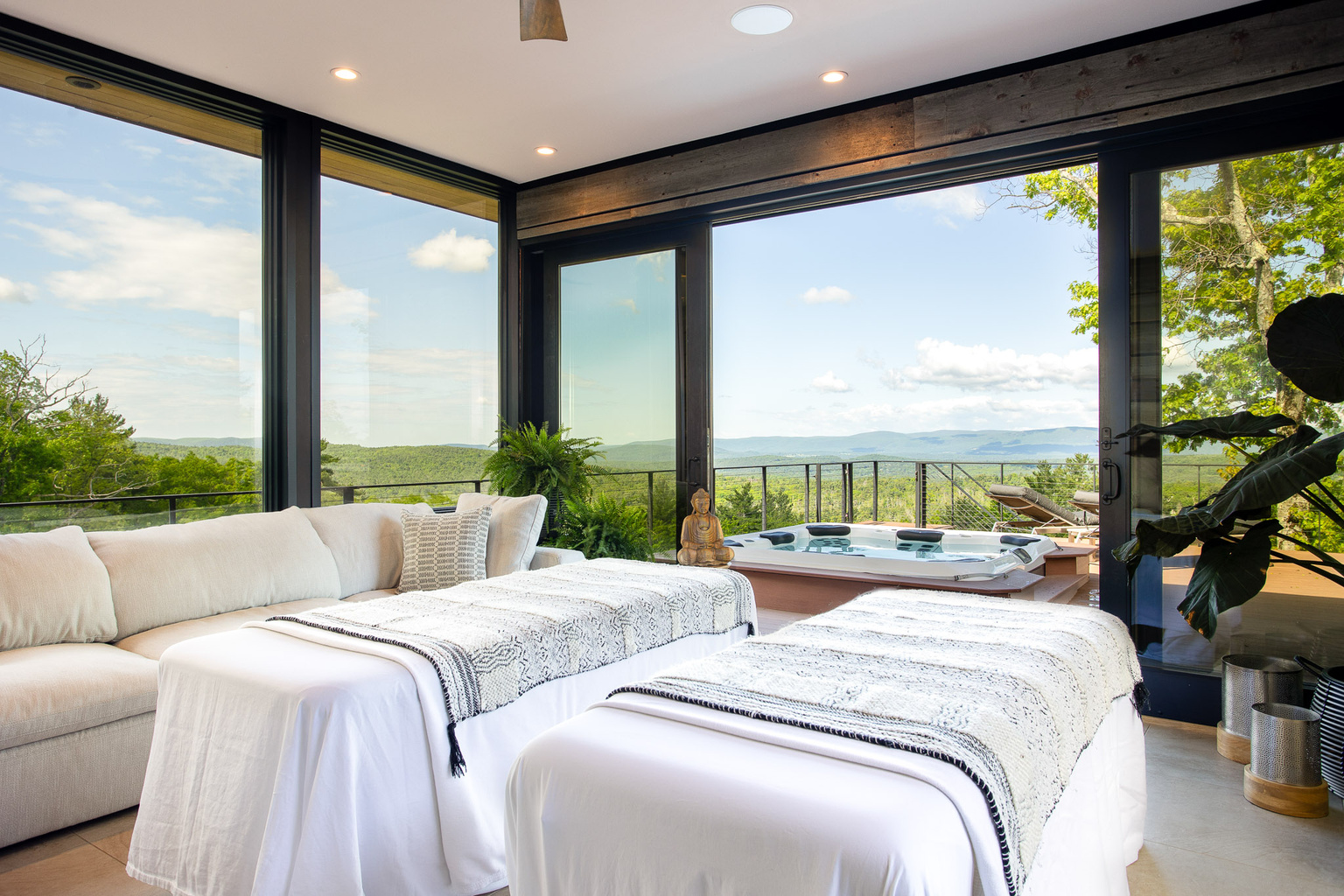 Massage tables in the sunroom at Sunset Falls, looking out over the hot tub and Berkshires valley