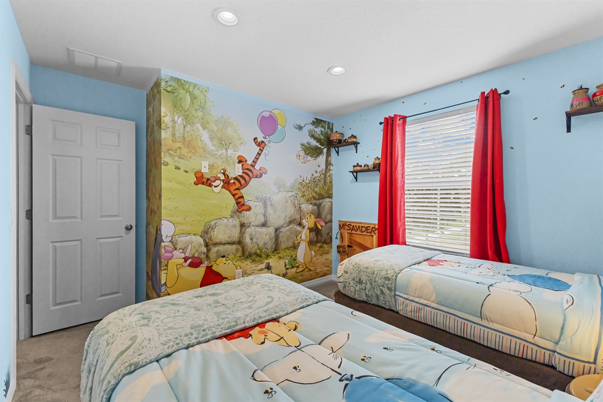 Winnie the Pooh themed twin bedroom designed for kids visiting Disney