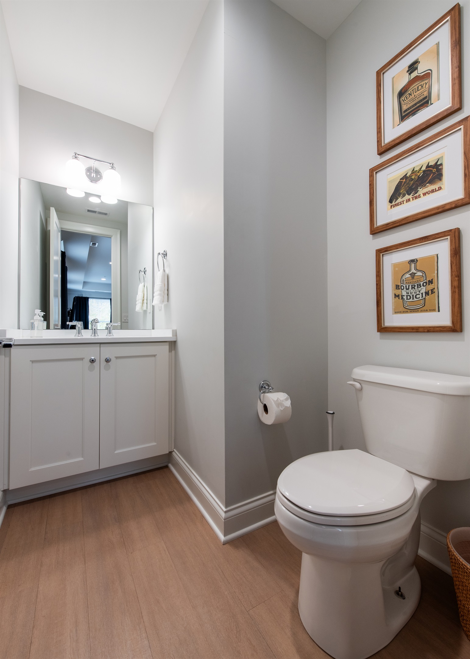 Conveniently located next to the family room, this stylish bathroom features modern fixtures, ample storage, and a touch of local flavor with bourbon-themed art. Ideal for your stay on the Bourbon Trail. 