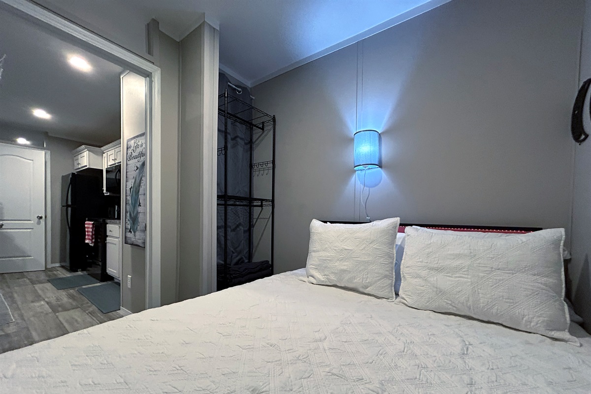 Bedroom #1 with queen bed, smart tv, en suite bathroom and hidden washer/dryer combo in closet