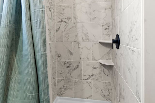 A sleek, tiled stand-up shower offering a modern and clean design.