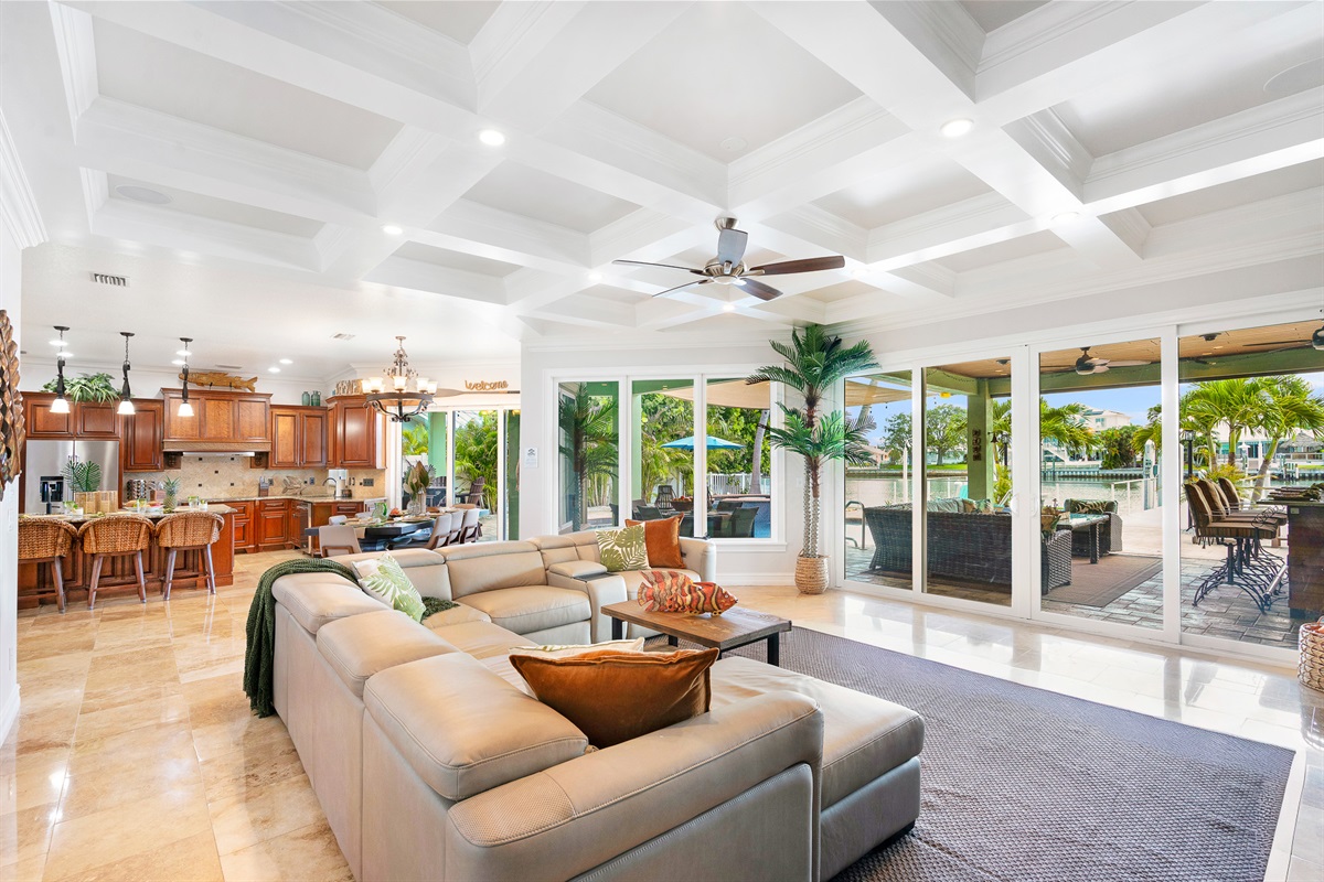 The ground floor living room opens to the outdoor kitchen and overlooks the pool and ocean.
