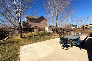 Bask in the sunshine and fresh air in this spacious backyard retreat. Whether enjoying a meal outdoors or unwinding under the trees, this space is perfect for relaxation.