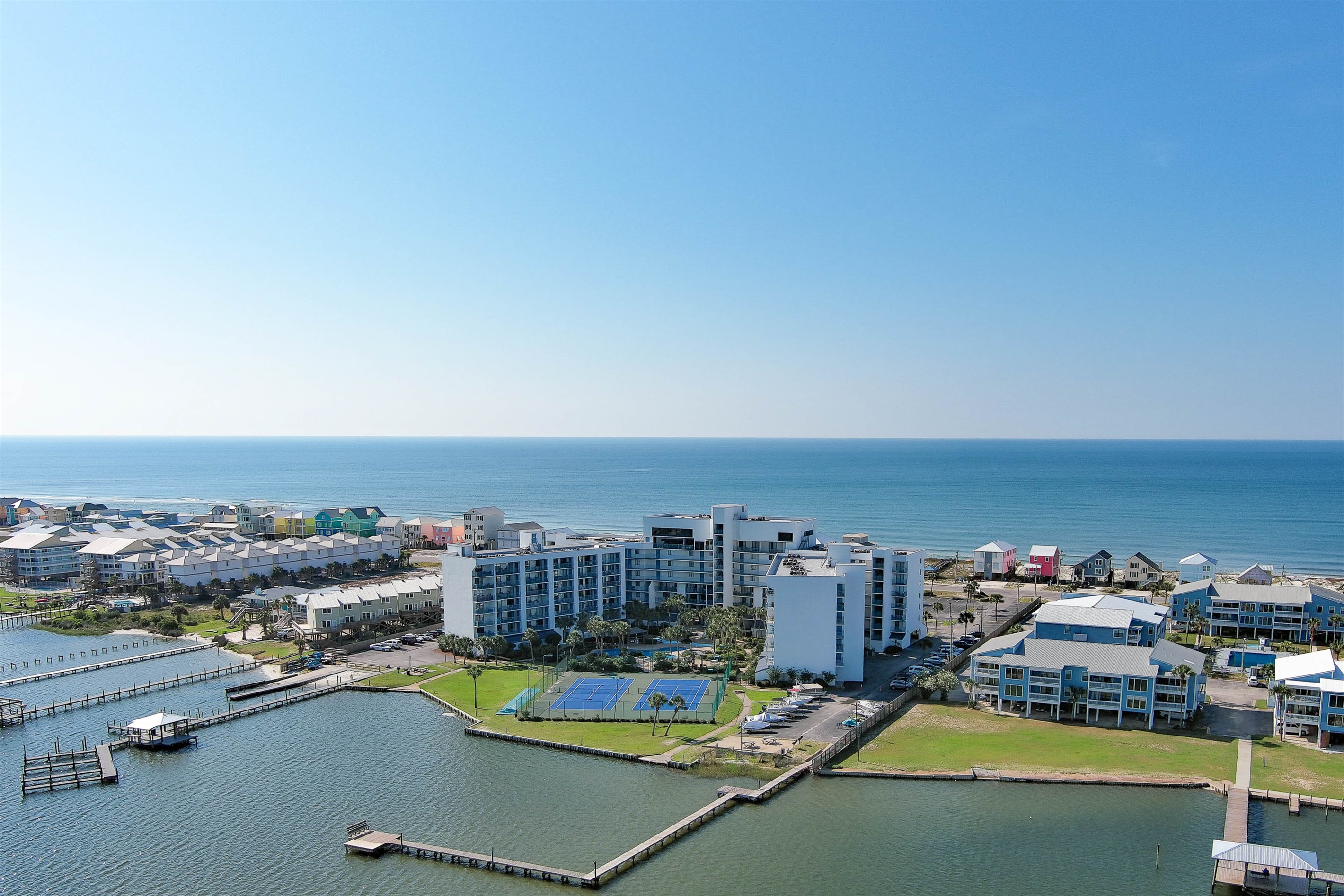 Paradise found: Experience private beach access and lagoon-side living at this premier Gulf Shores Surf and Racquet Club.