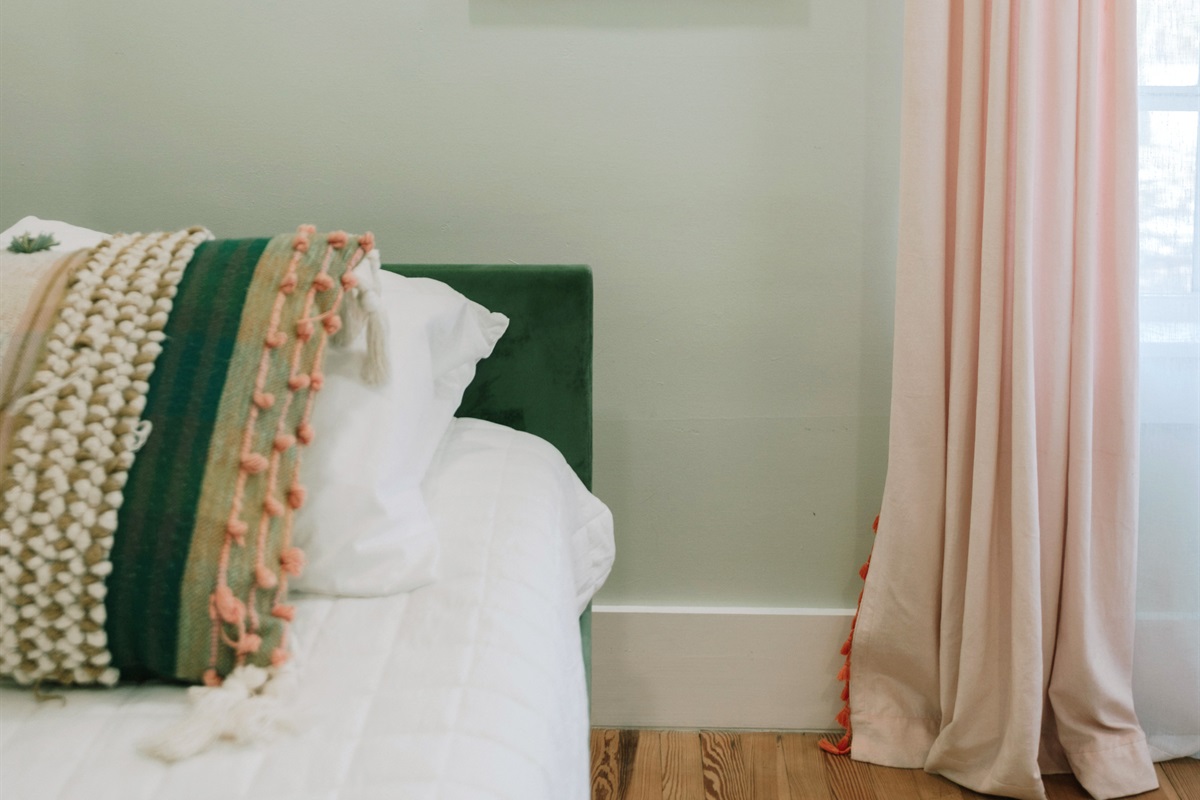 The third bedroom has a daybed and a pullout bed, garnished with colorful art throughout.