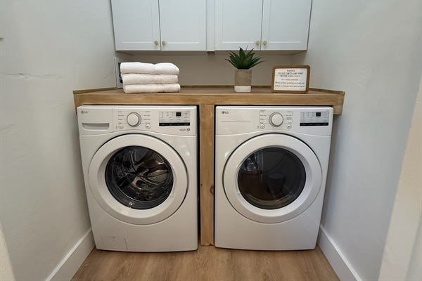 Laundry room featuring a full size washer and dryer and an extra large folding station