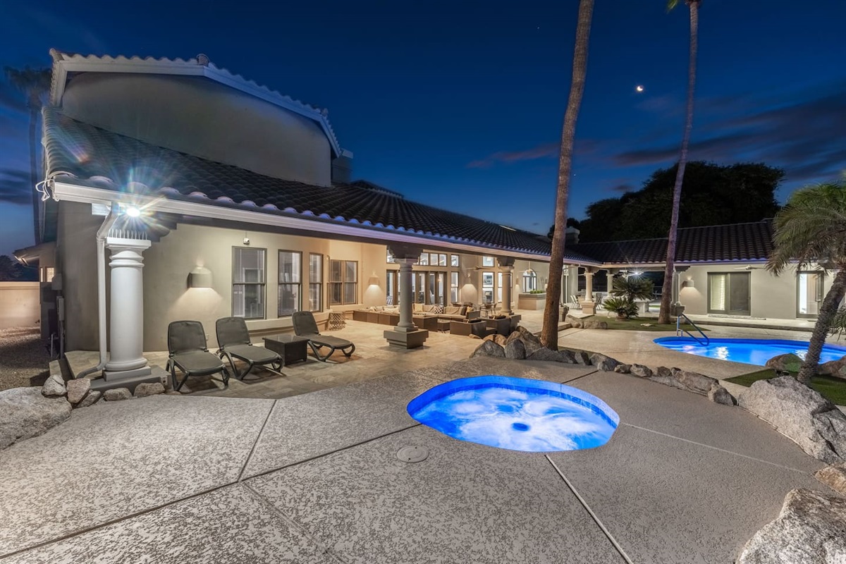 Relax under the night sky with the soothing hot tub jets and elegant patio ambiance.