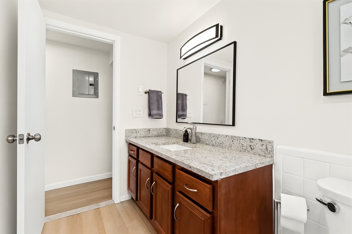 Get ready with ease at this well-lit vanity, complete with a large mirror, modern lighting, and plenty of counter space for your essentials.
