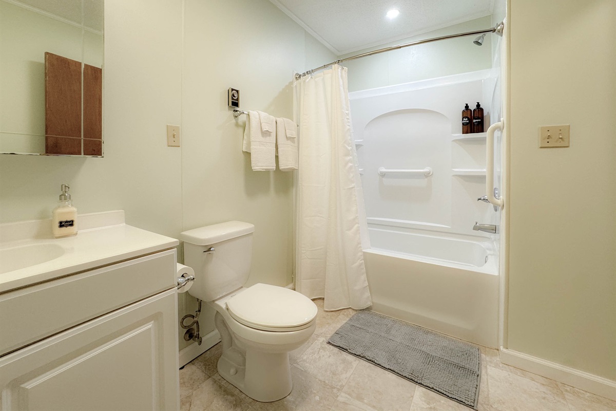 The guest bathroom is a nice size full bathroom complete with a tub/shower combination, toilet, and vanity. The bathroom is centrally located in the hallways between the two guest bedrooms.