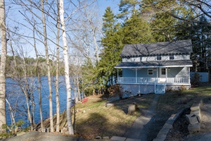 View from the parking lot looking towards the stairs to get to the walk way and stairs up into the house