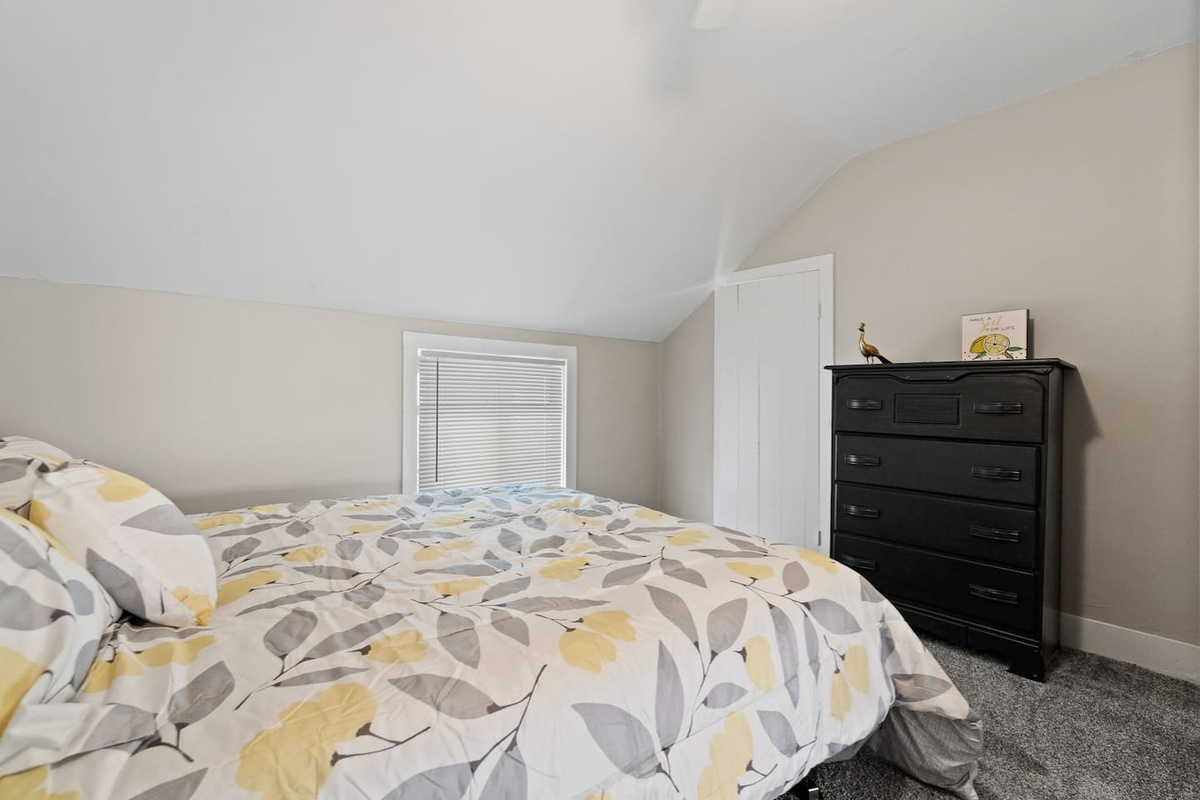 Cozy bedroom featuring a set of spacious drawers, offering ample storage for your belongings while keeping the room organized and clutter-free.