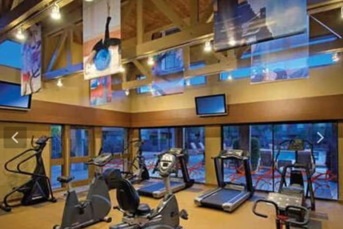 A full community fitness studio with cardio machines overlooking the courtyard — no excuse to skip your workout on vacation.