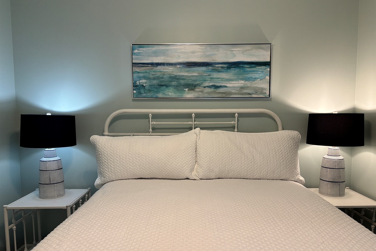 Comfortable queen bedroom with a clean, coastal feel and plenty of space to settle in.