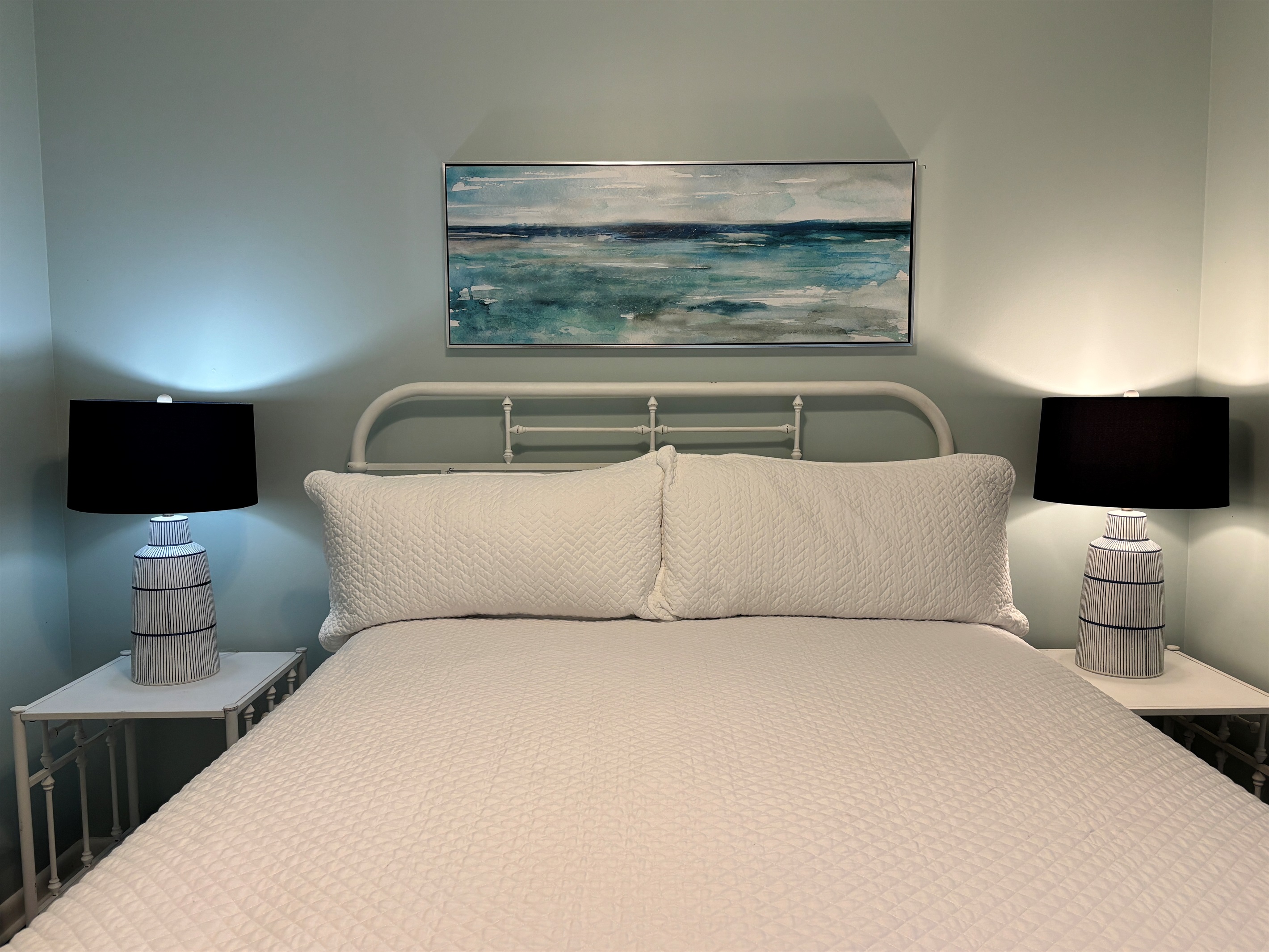 Comfortable queen bedroom with a clean, coastal feel and plenty of space to settle in.