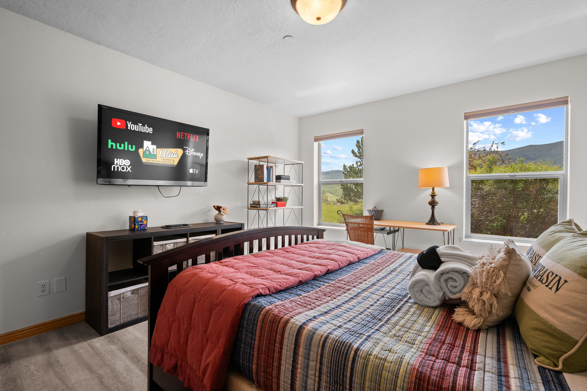Unwind in the spacious primary bedroom complete with scenic views, Smart TV entertainment, and cozy furnishings.