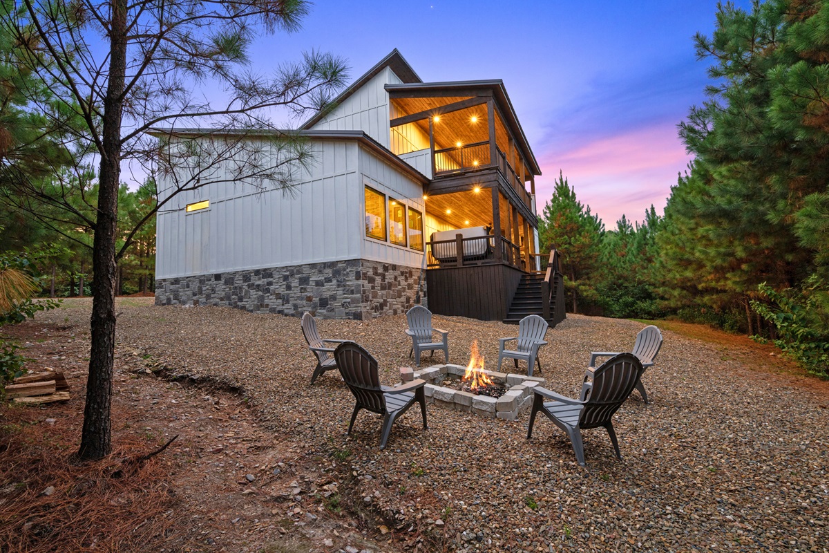 Charming cabin exterior with a cozy firepit hangout below.