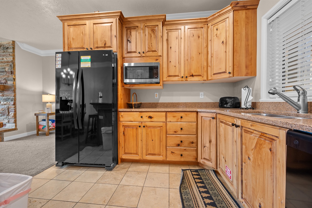 Well-stocked kitchen with appliances and ample counter space.