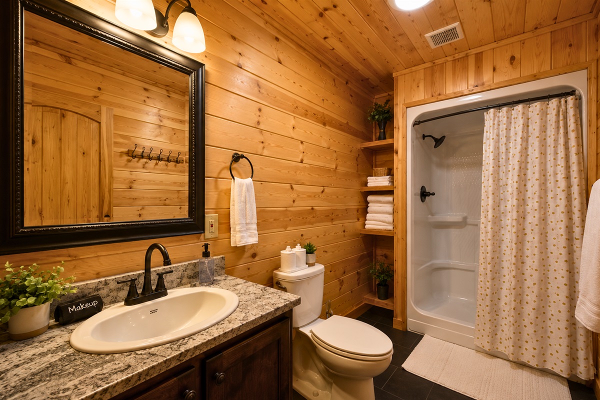 Plenty of counter space and warm wood details make this bathroom both functional and inviting for guests.