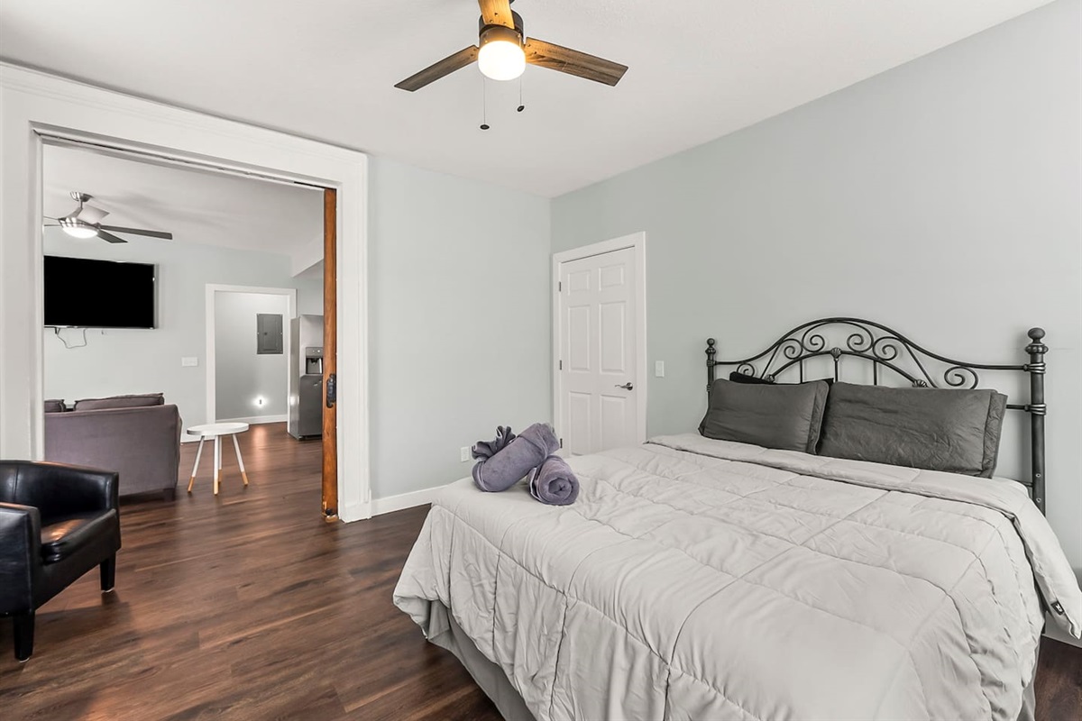 Primary bedroom with elegant antique pocket door access, connecting seamlessly to the living area.