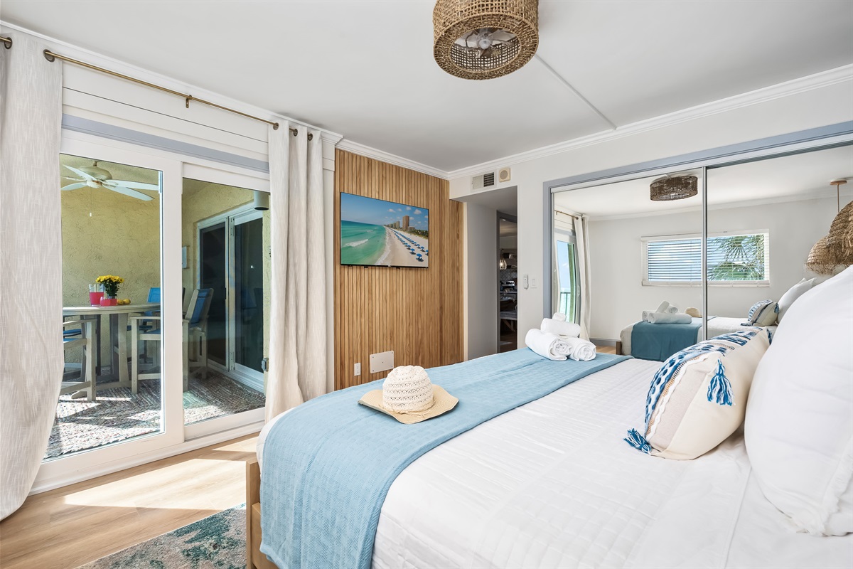 King suite includes sliding closet doors, wood accents, and balcony access.
