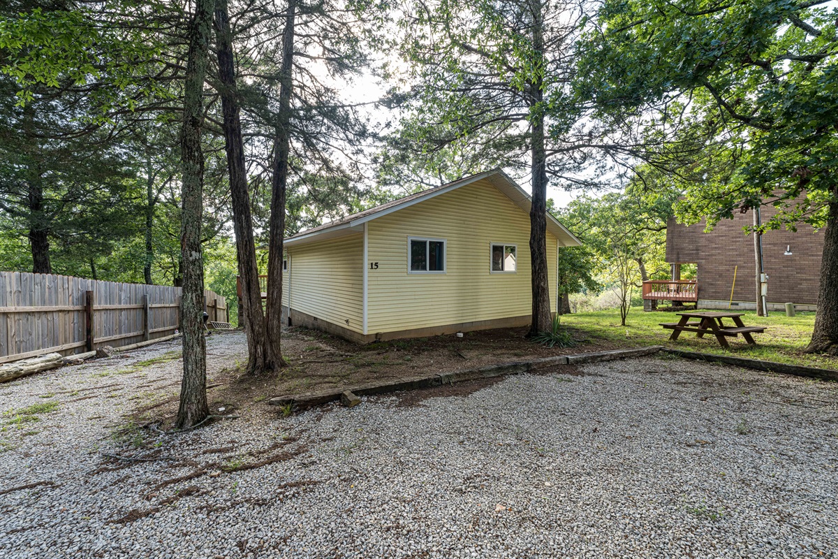 Cabin 15 has a picnic table and a charcoal grill