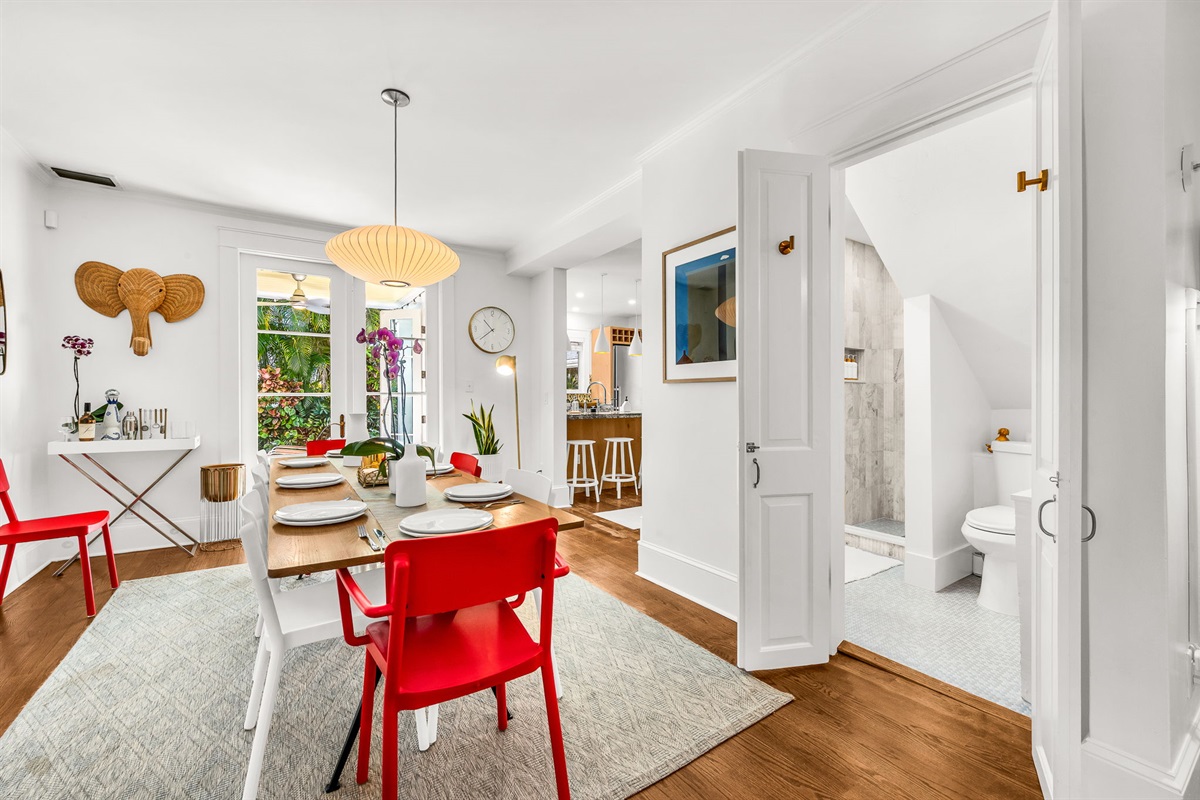 Tucked discreetly off the dining room, this hidden brand-new full bathroom features modern champagne gold fixtures, an LED lit vanity mirror and floating vanity, and a step-in luxury shower —proof that even the smallest spaces can shine.