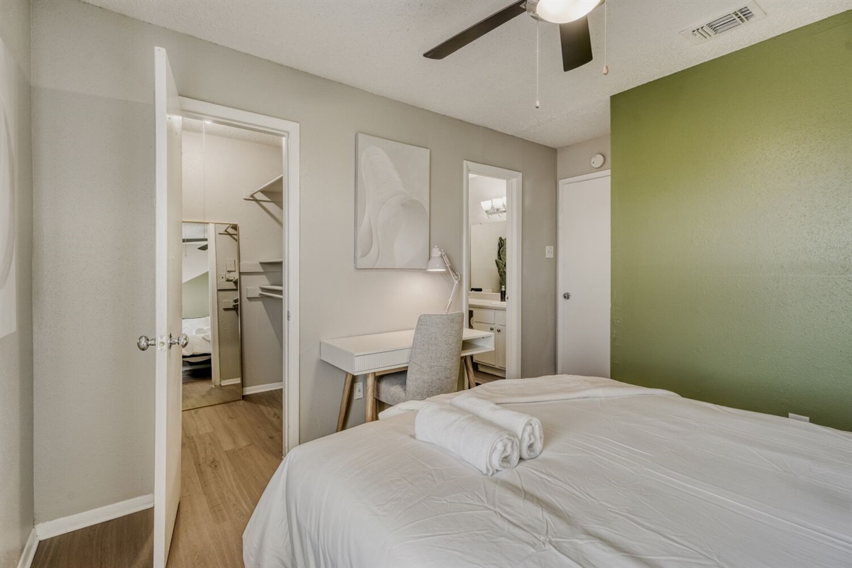 Inviting bedroom with a soft green accent wall.
