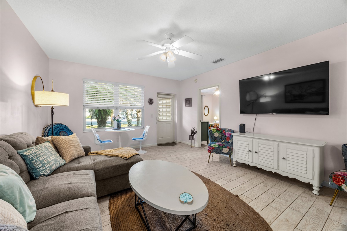 Open living space with ceiling fan, warm lighting, and plenty of room to unwind.