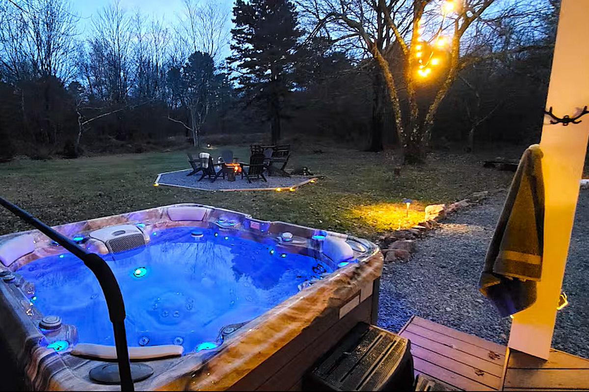 Enjoy soaking in the hot tub while surrounded by nature and watching the sunset.