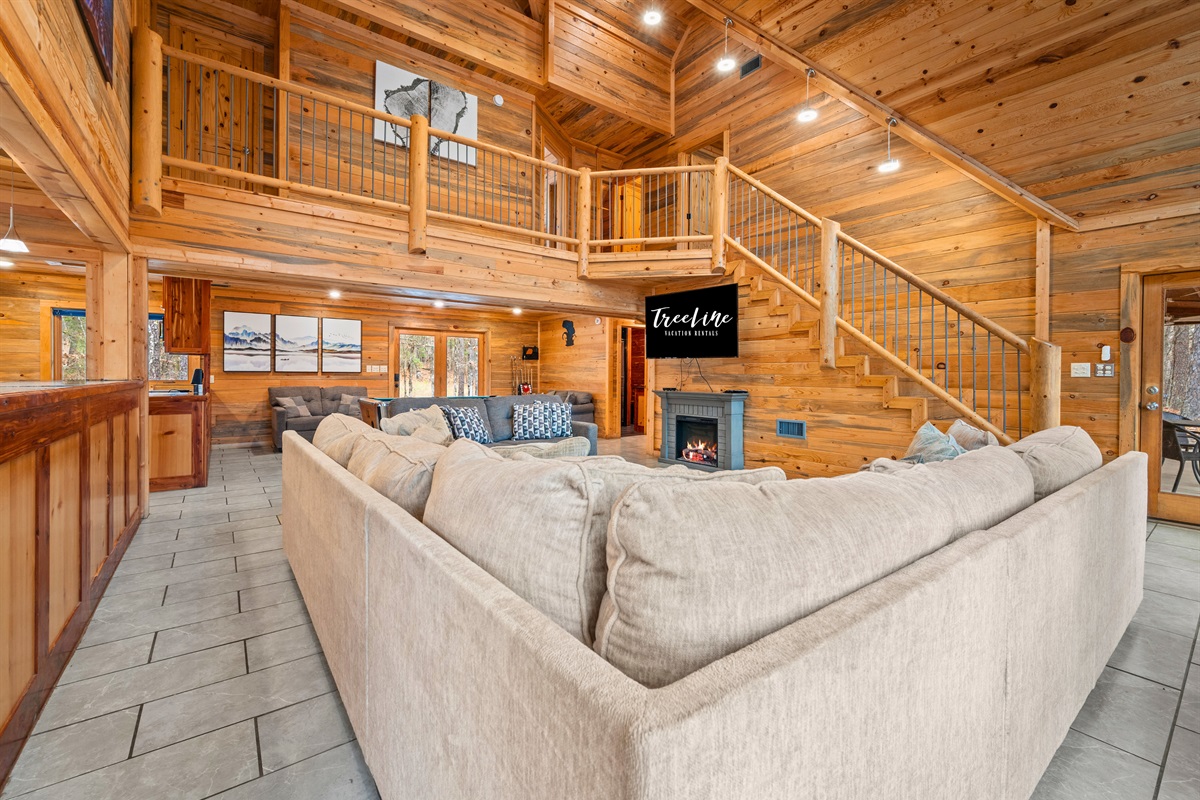 Surrounded by warm wood tones, this cozy seating area is ideal for movie nights, conversations, or quiet moments.