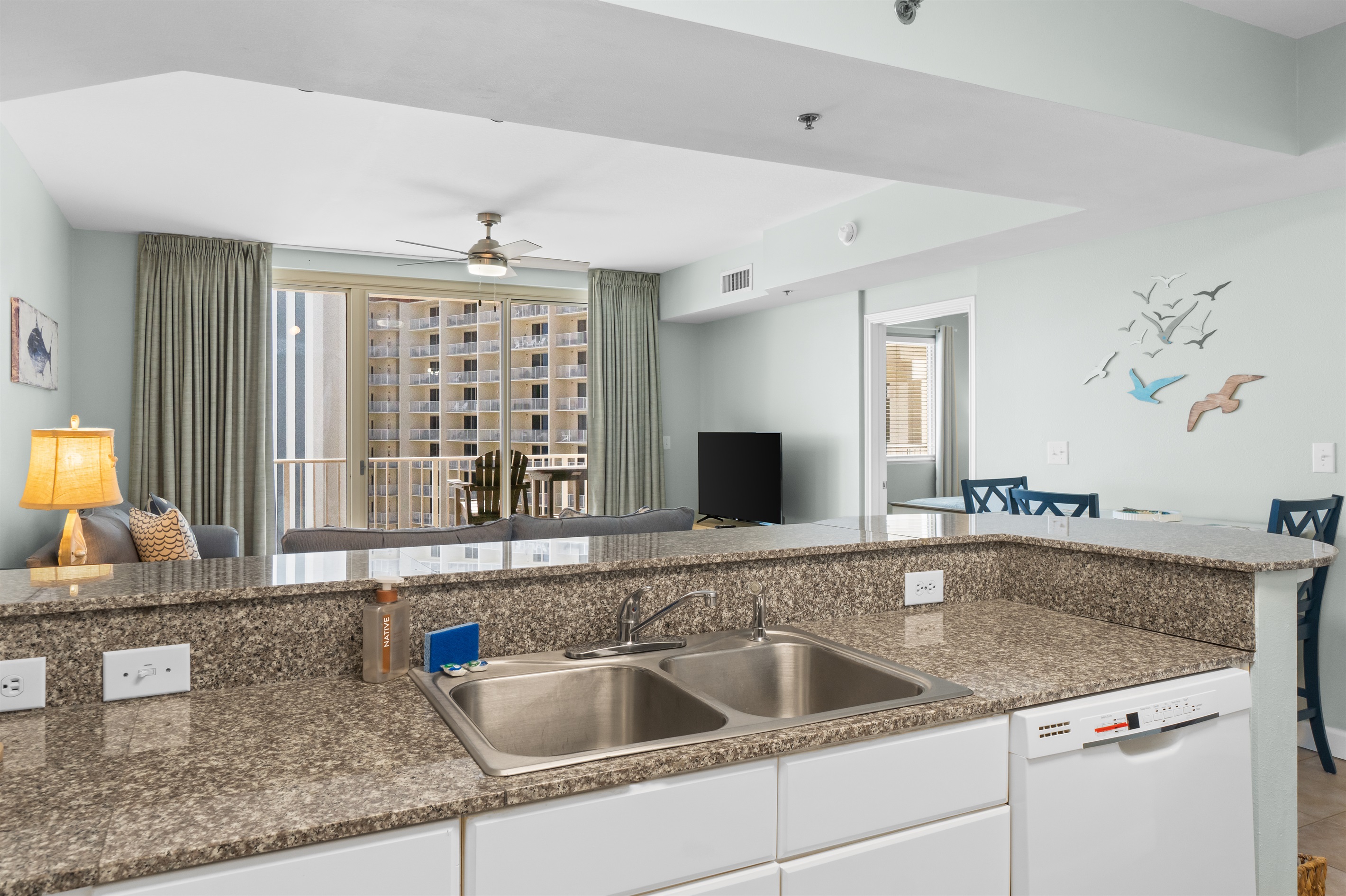 Kitchen directly faces the living room and balcony. 