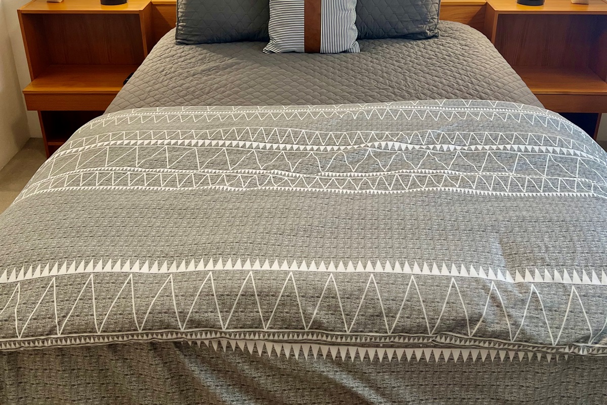 Enjoy a peaceful night's sleep in the inviting secondary bedroom, complete with a plush queen-size bed and soft linens.  Keep your belongings organized and easily accessible with the spacious closet, convenient drawers, and bedside nightstand.