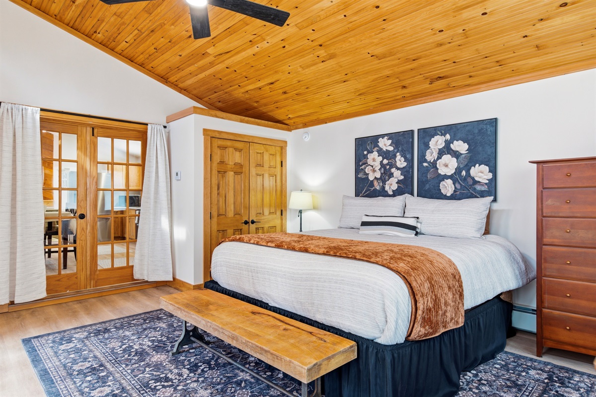 Sleep under the soaring wood ceilings of our primary suite, a masterfully designed retreat for your Bethel getaway.