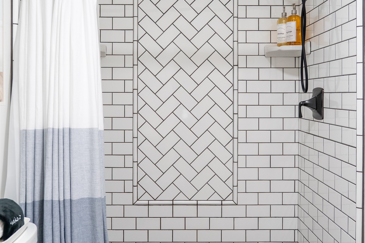 A bright, modern shower with spa-quality amenities ready for your stay.