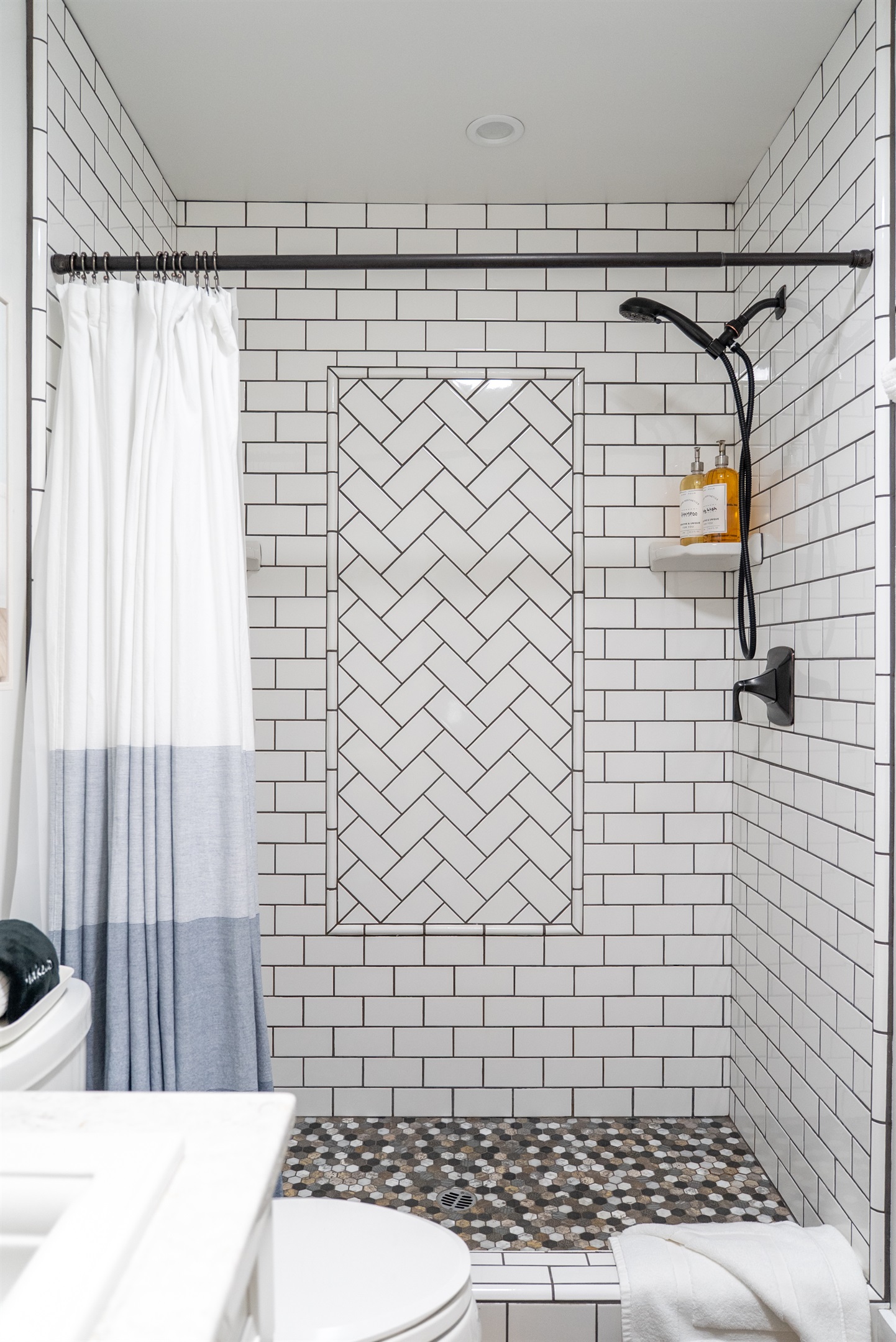 A bright, modern shower with spa-quality amenities ready for your stay.