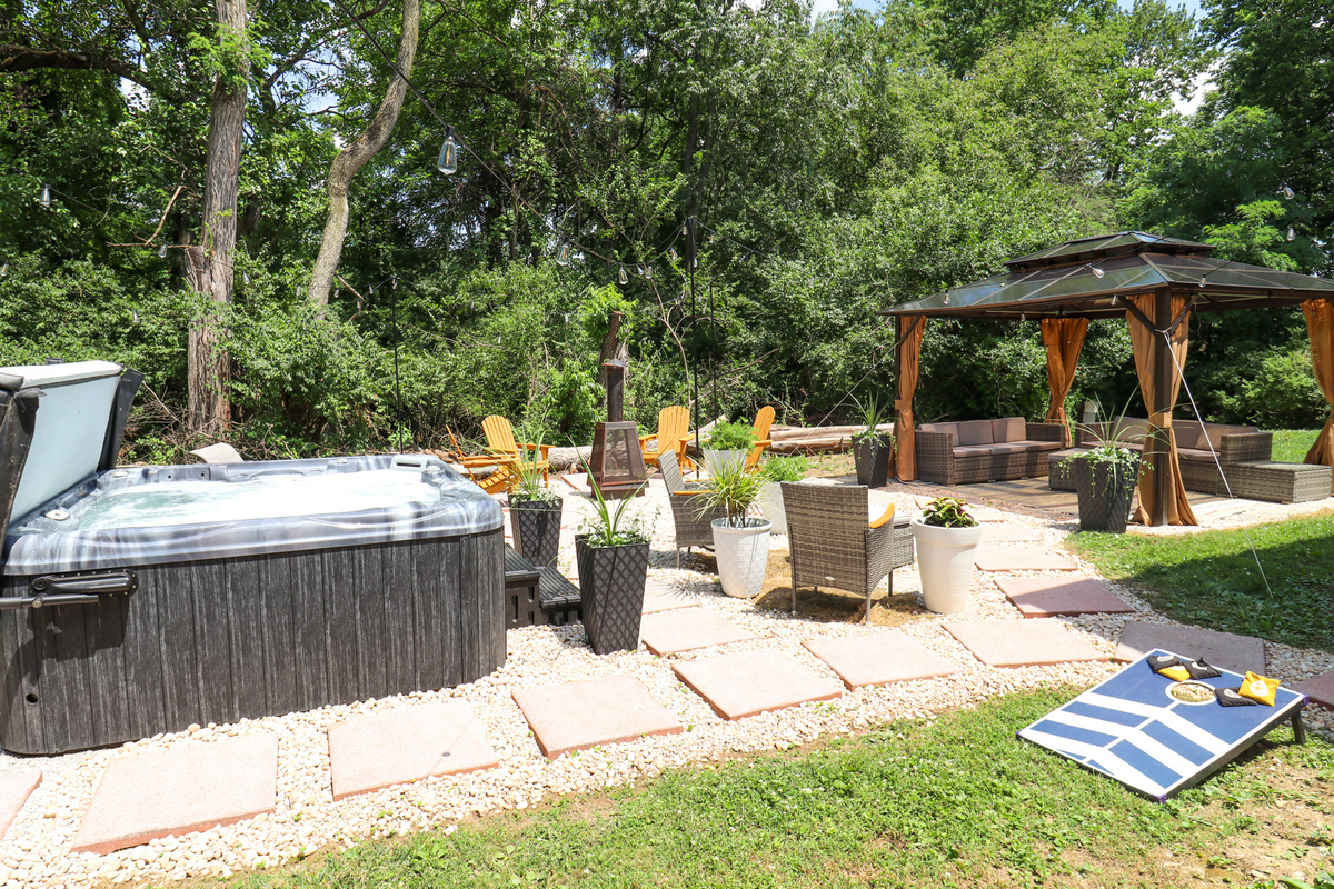 Whether you're soaking in the hot tub or relaxing by the fire, this outdoor space was made for unforgettable evenings.