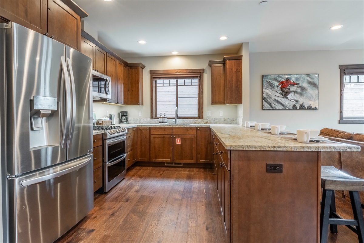 Designed for gathering and ease, this fully equipped kitchen offers generous prep space, modern appliances, and seamless flow into dining and living areas.