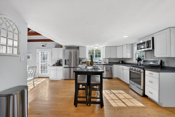 Bright, airy kitchen stocked with everything you need to prepare meals.