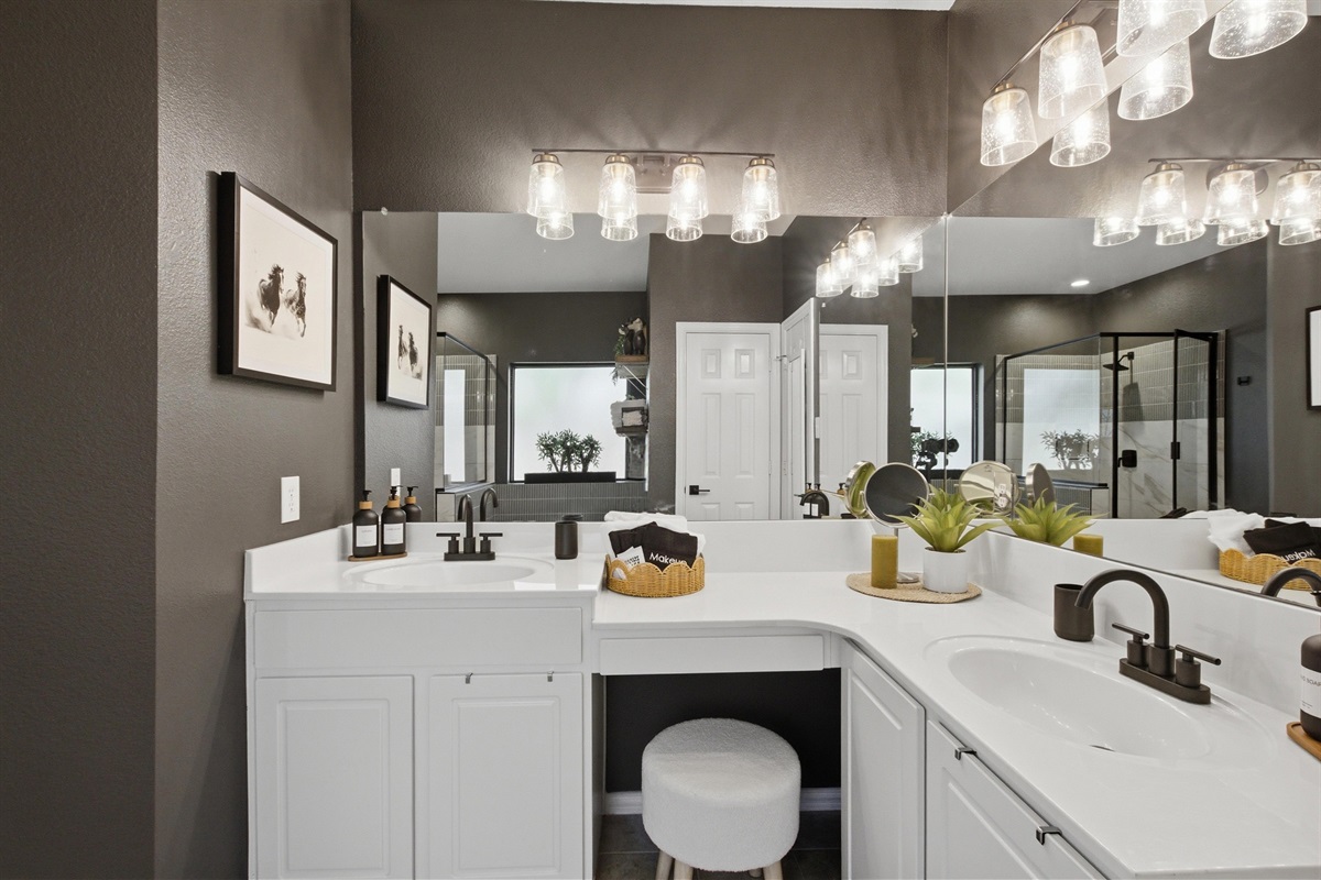 Master Bathroom double Vanity with dual mirrors, ample counter space, and warm pendant lighting. Stocked with essentials by Ginger Lily Farms.
