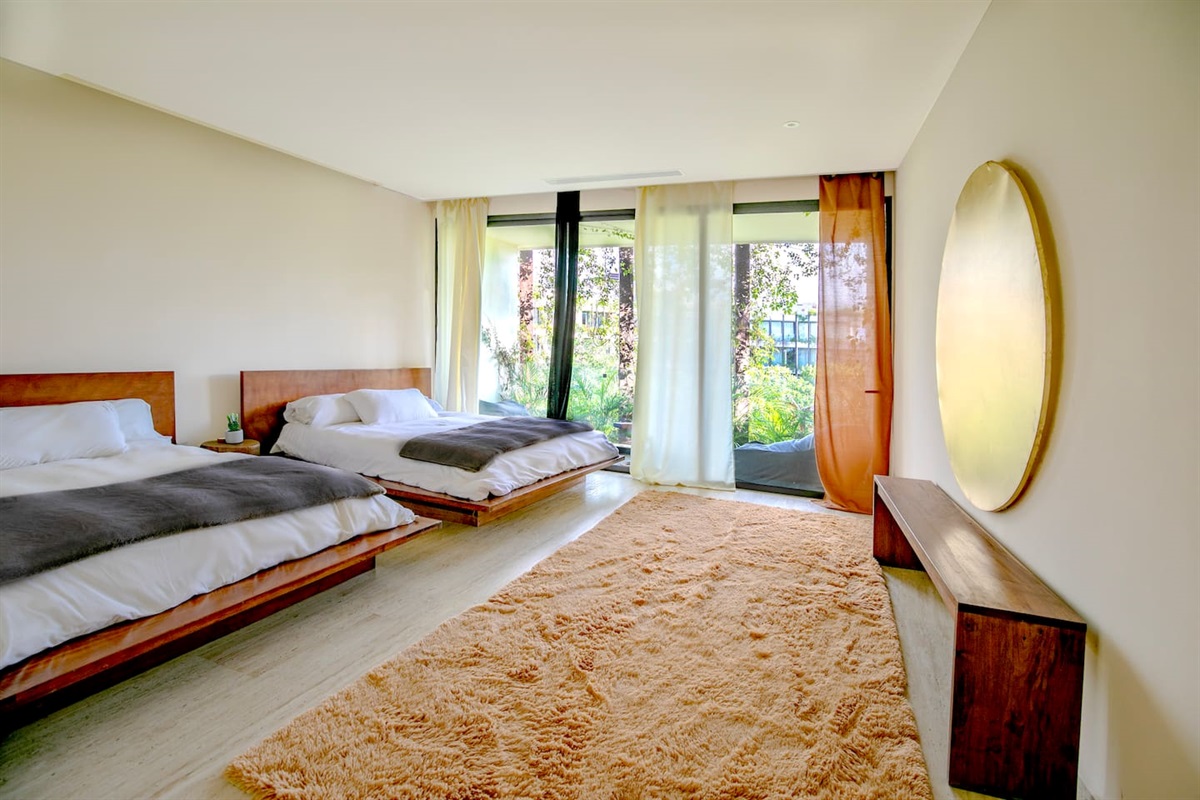 Bedroom #2 with 2 Queen sized beds, ample closet space and private balcony and ensuite 