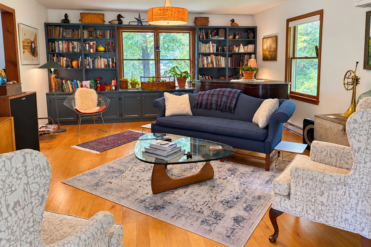 Living room with comfortable seating and a piano.