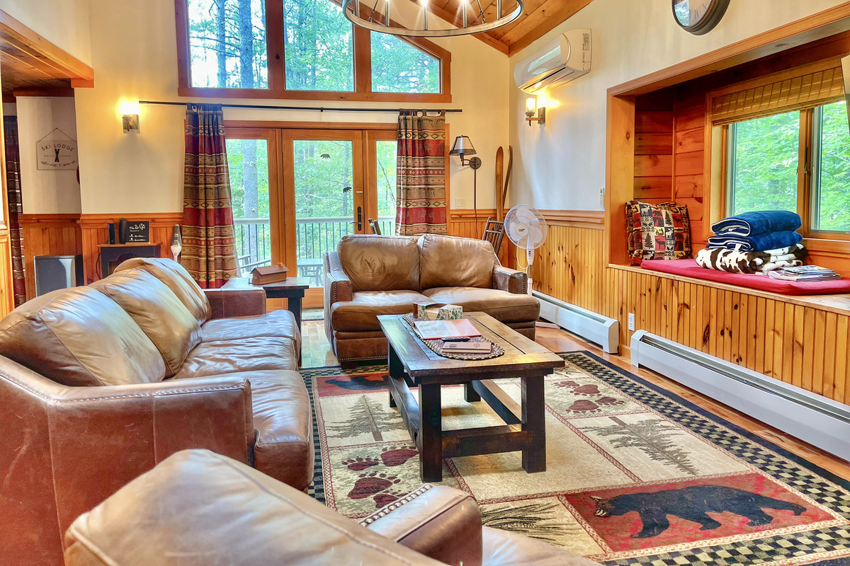 Enjoy views of soaring trees from our stylish living area, furnished in Adirondack style with leather seating.