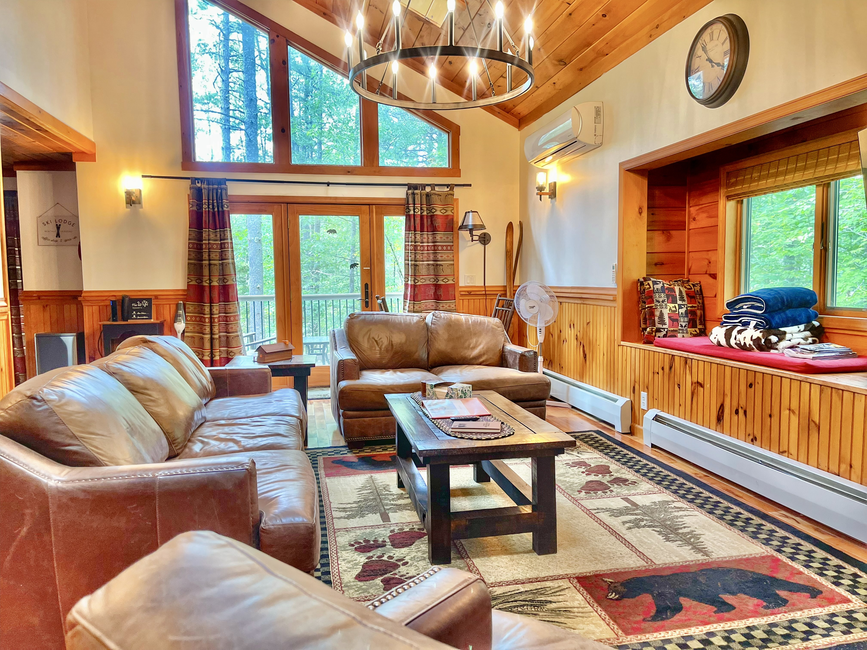 Enjoy views of soaring trees from our stylish living area, furnished in Adirondack style with leather seating.