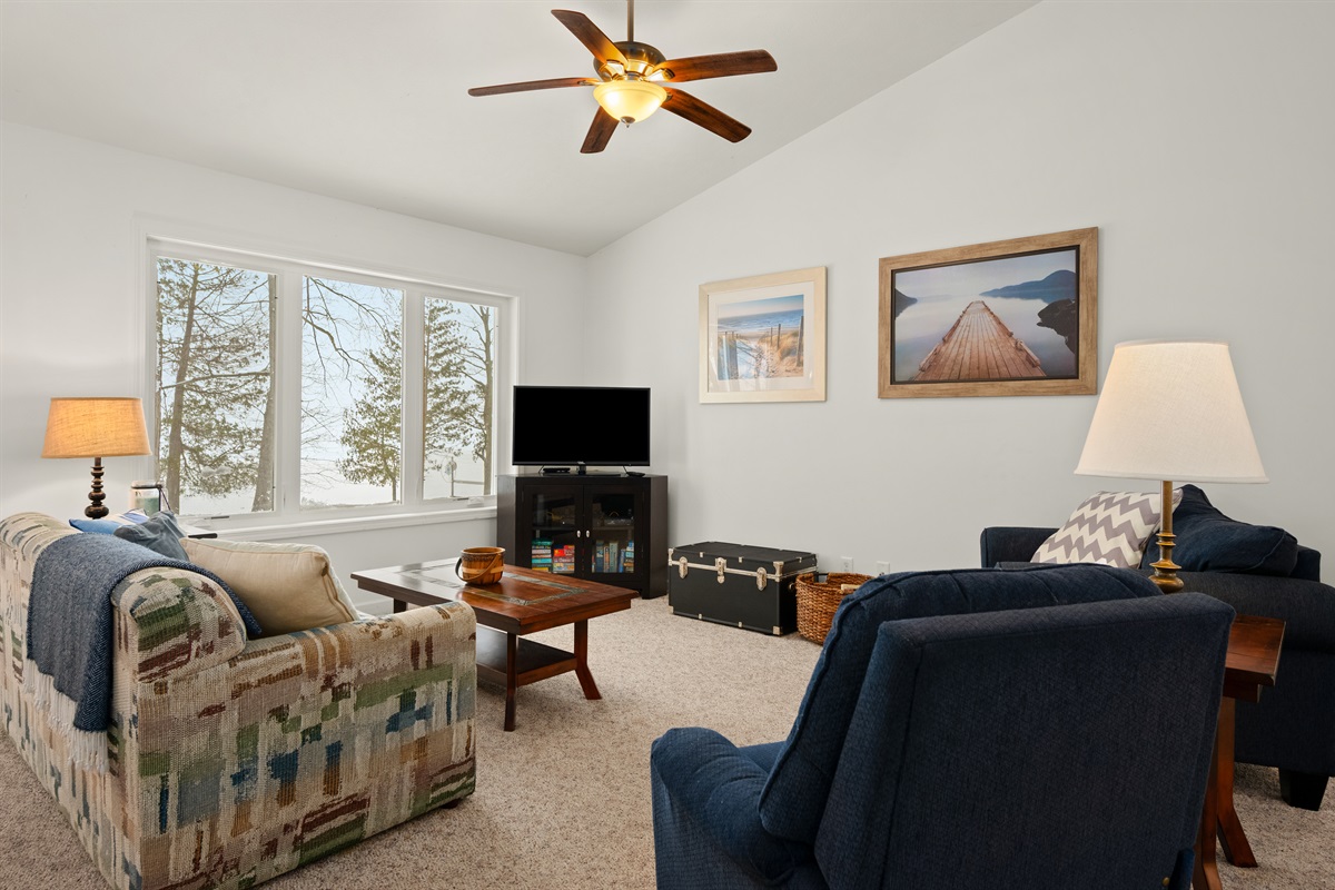 Living room seating with large windows and natural light