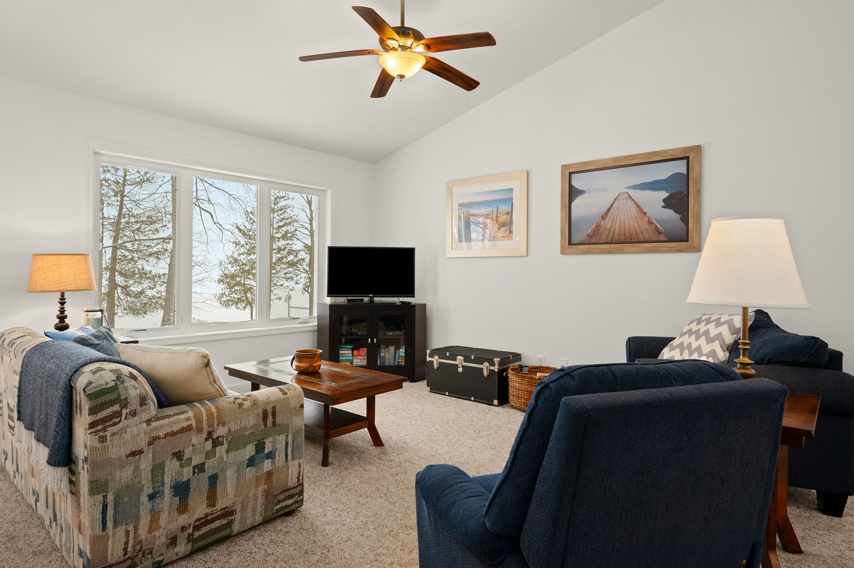 Living room seating with large windows and natural light