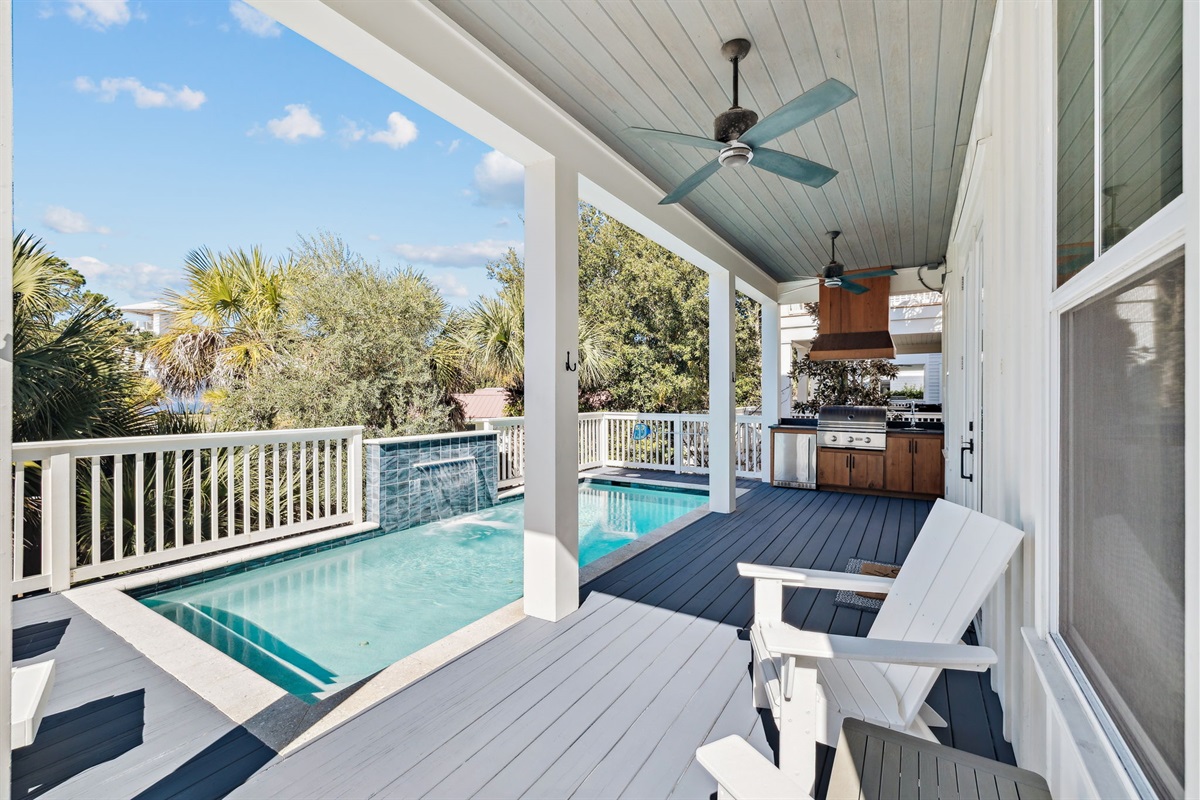 Private outdoor pool area conveniently located just outside the living room and kitchen, featuring a heated pool with a beautiful waterfall, seating and loungers, plus an outdoor grill and kit