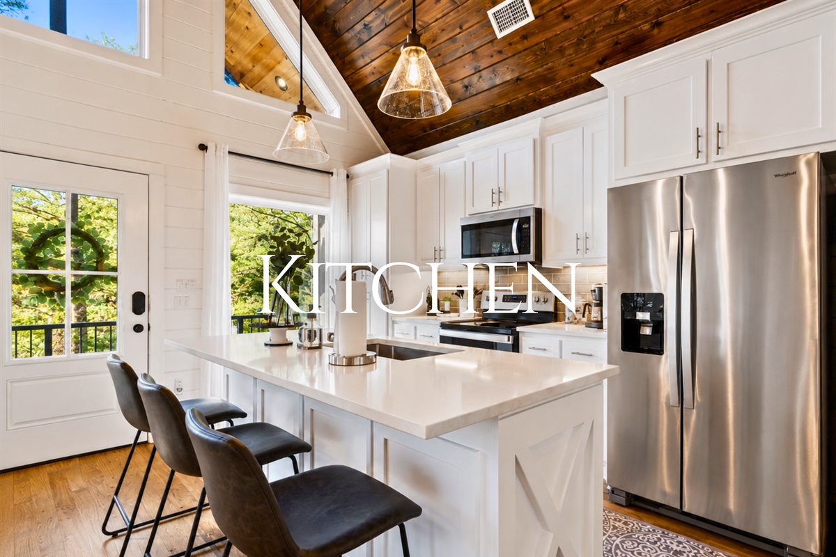 The bright and open kitchen offers modern appliances, beautiful finishes, and plenty of space to cook a quiet dinner together during your stay.