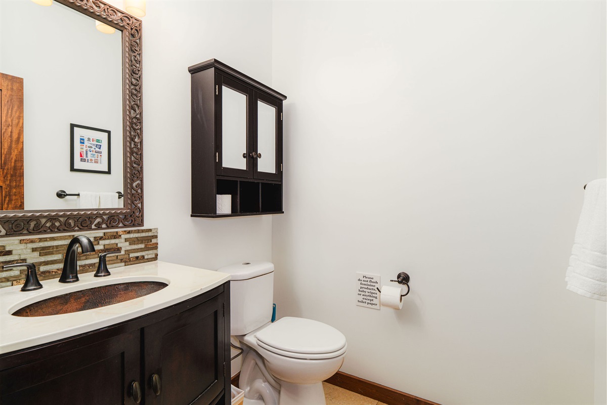 Convenient half bath located on the main level for easy access during gatherings and game nights.