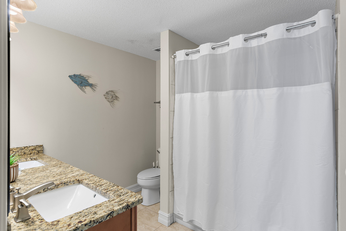 Spacious master bedroom features a King bed, Gulf views, balcony access, SMART TV w/ cable access, bathroom with dual vanity and shower/tub combo, and large closet.