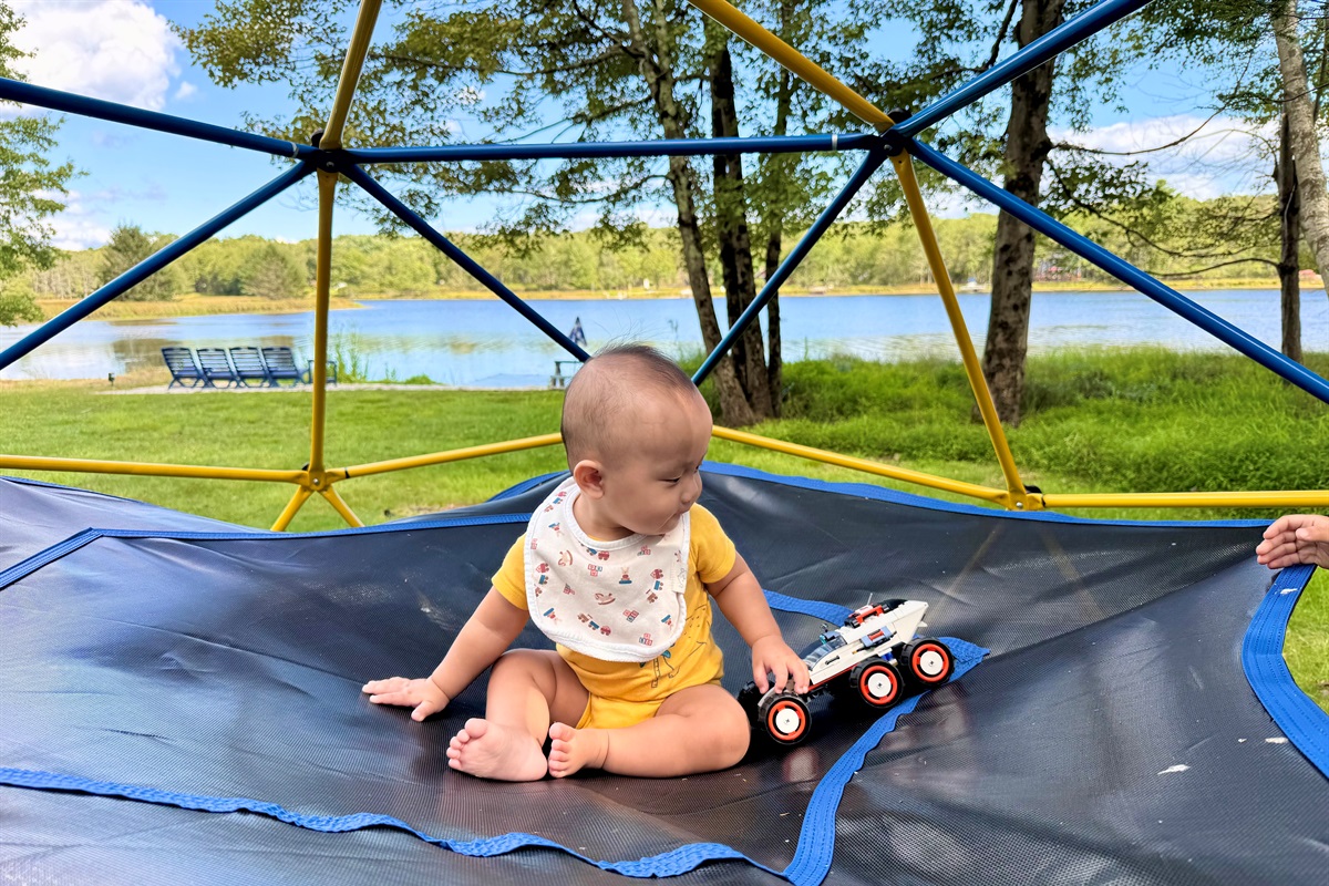 Little feet exploring big adventures — joy on the climbing dome.
